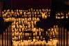 A piano in a church surrounded by candles