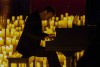 A piano in a church surrounded by candles