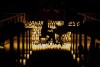 A piano in a church surrounded by candles