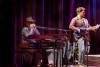 David Zeman plays the harmonica while John McAllister strums the guitar during The Pettybreakers concert at the Fox Theatre in Riverside Ca on Jan 20 2024