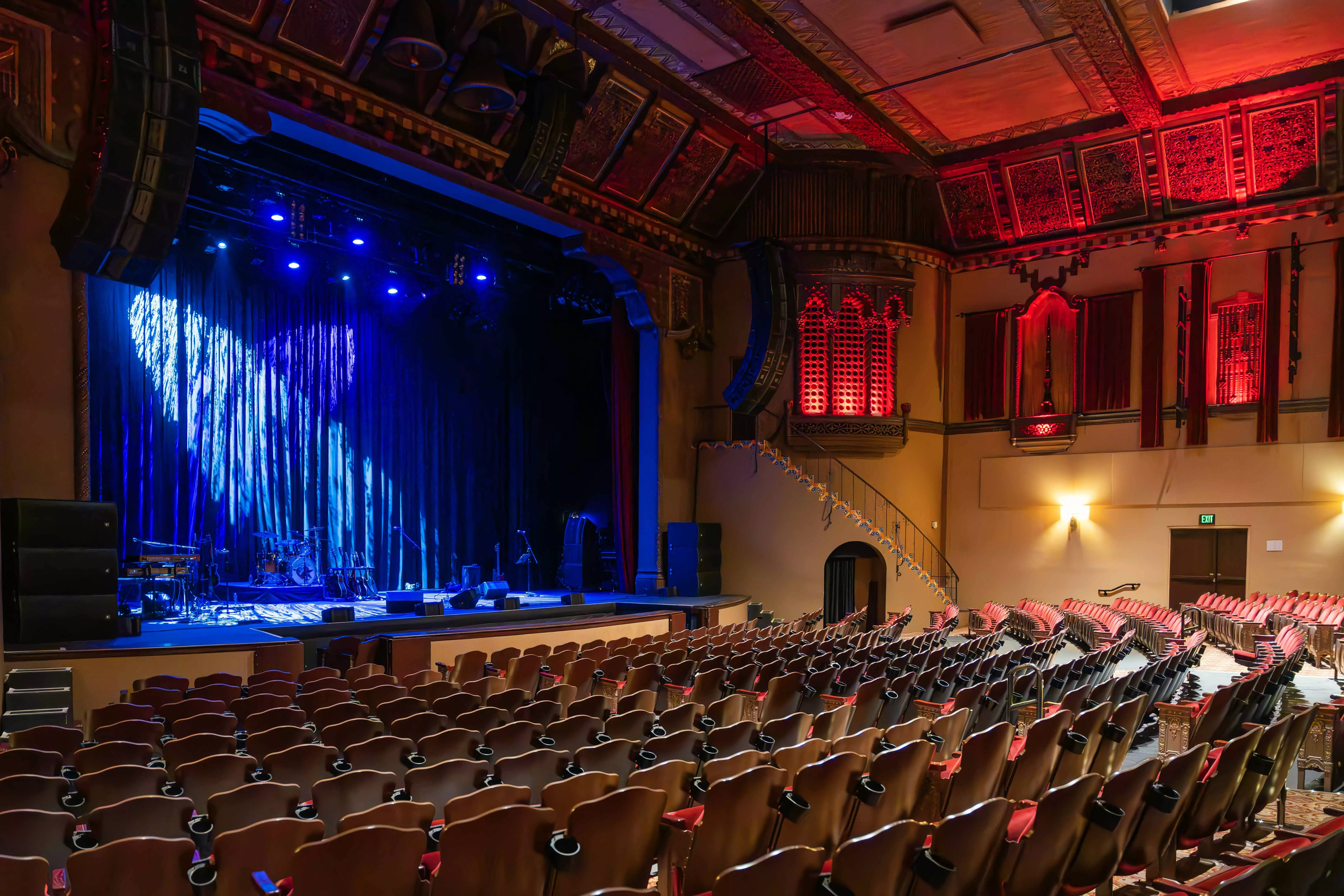 Interior shot of the Fox Theatre with blue lighting on the stage setup for a band to perform