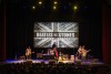 A tribute band impersonating the Rolling Stones performs on the stage at Fox Performing Arts Center