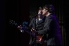 A tribute band impersonating the Beatles plays on the stage at Fox Perfoming Arts Center