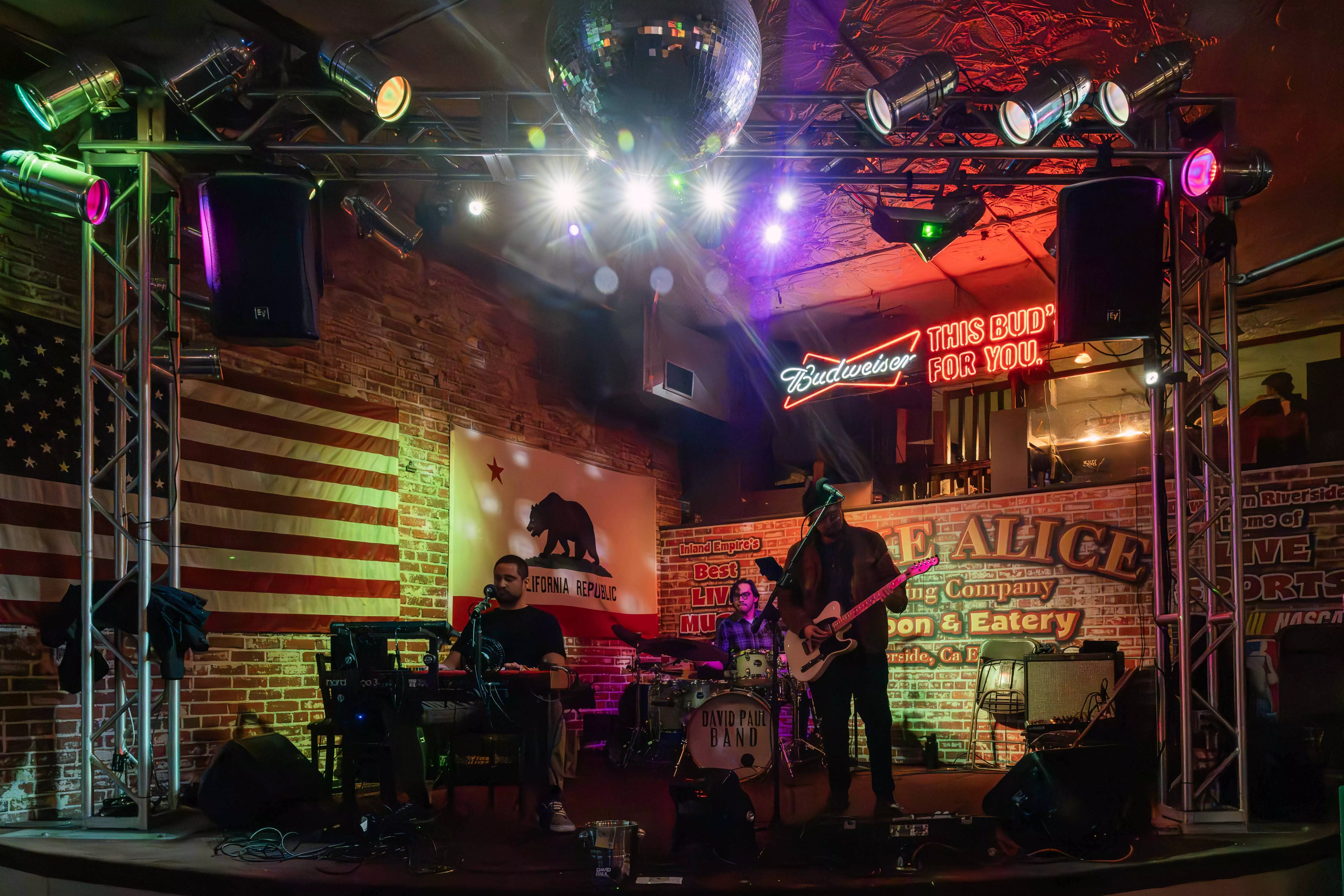 Three members of a band perform at a local restaurant and bar