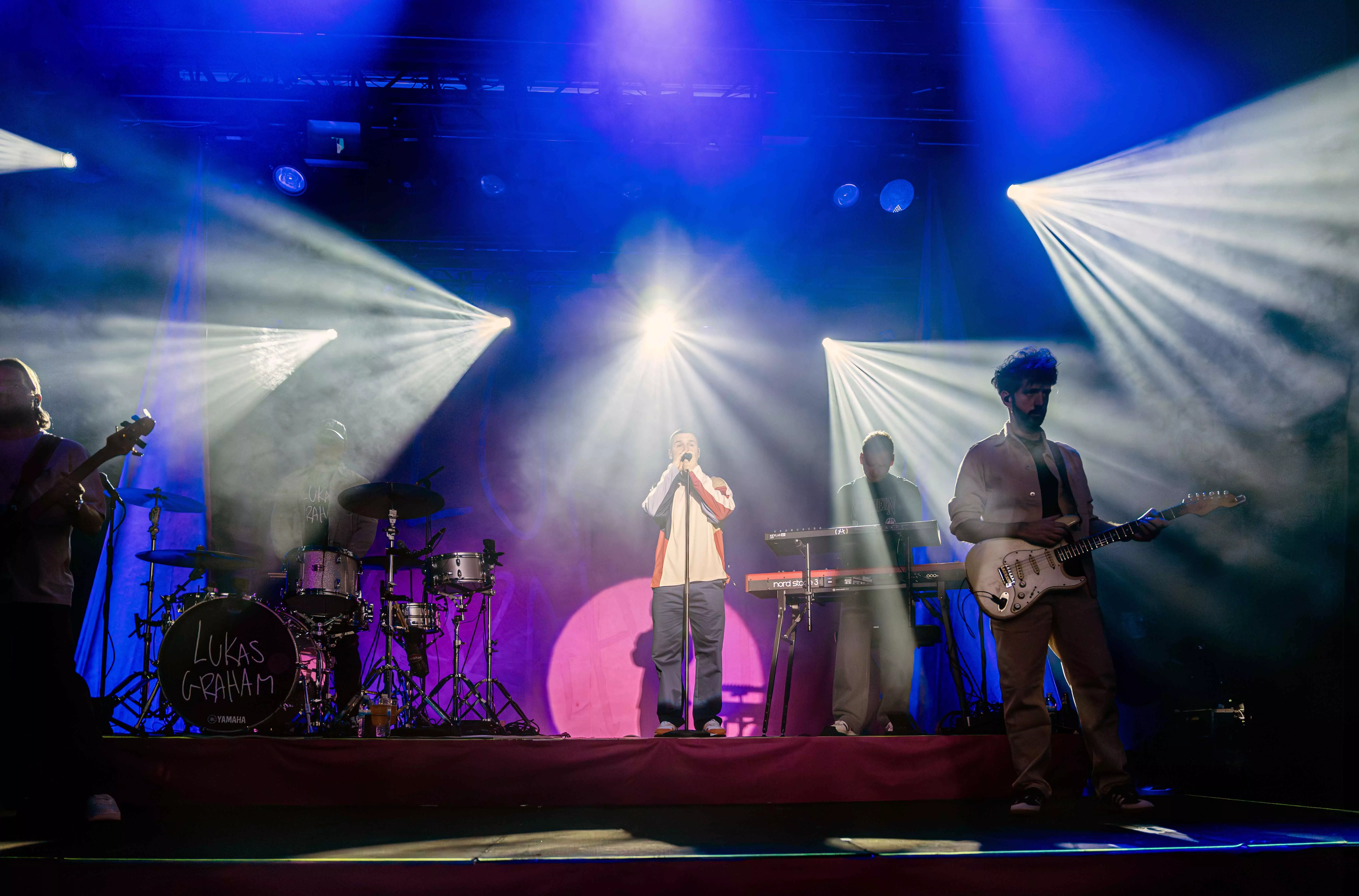 Performers on stage playing music