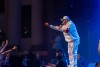 MC Magic tosses a rose to an eager fan during their performance at the Riverside Municipal Auditorium on August 24