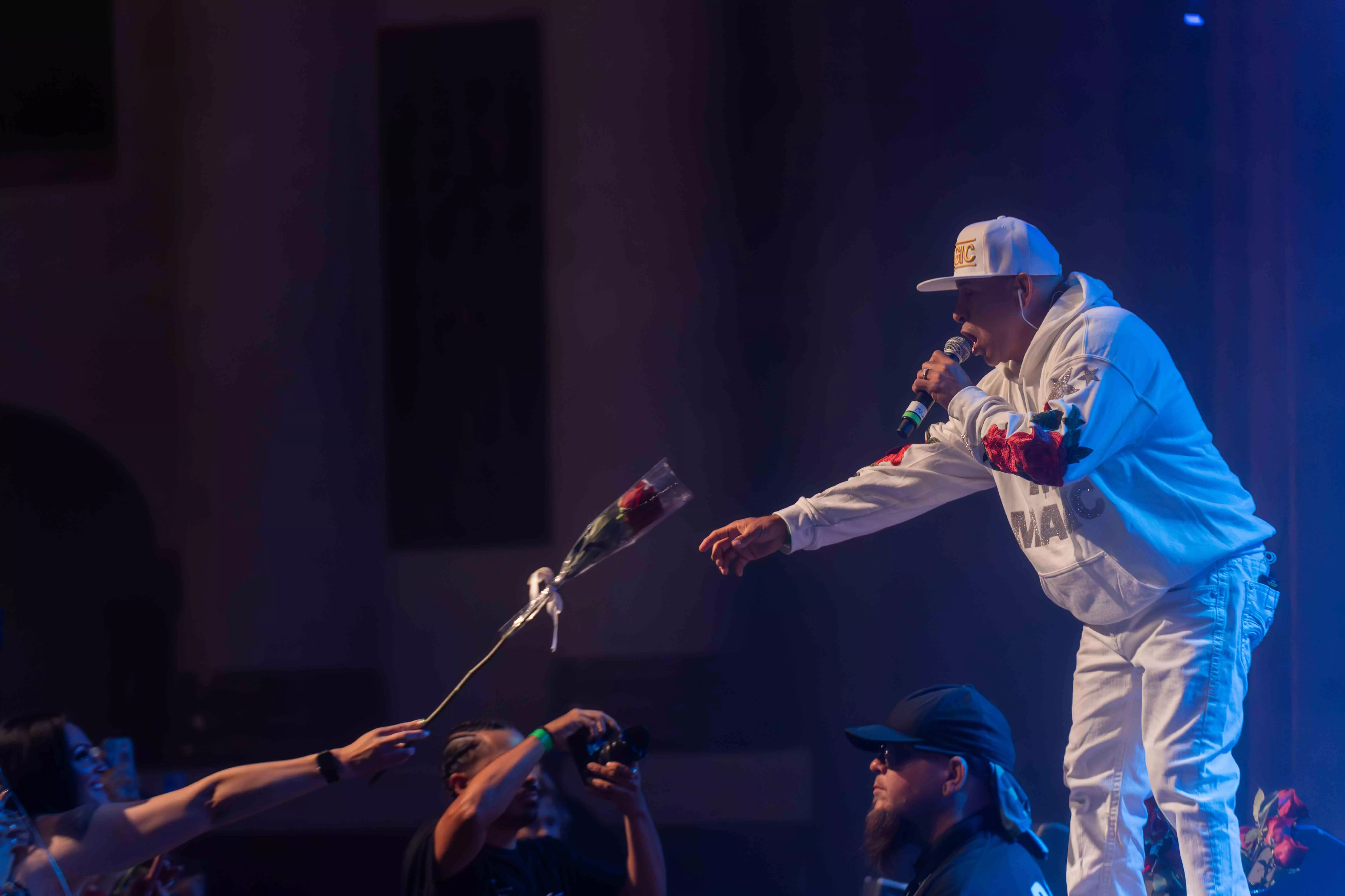 MC Magic takes a rose from a fan during his performance at the RMA