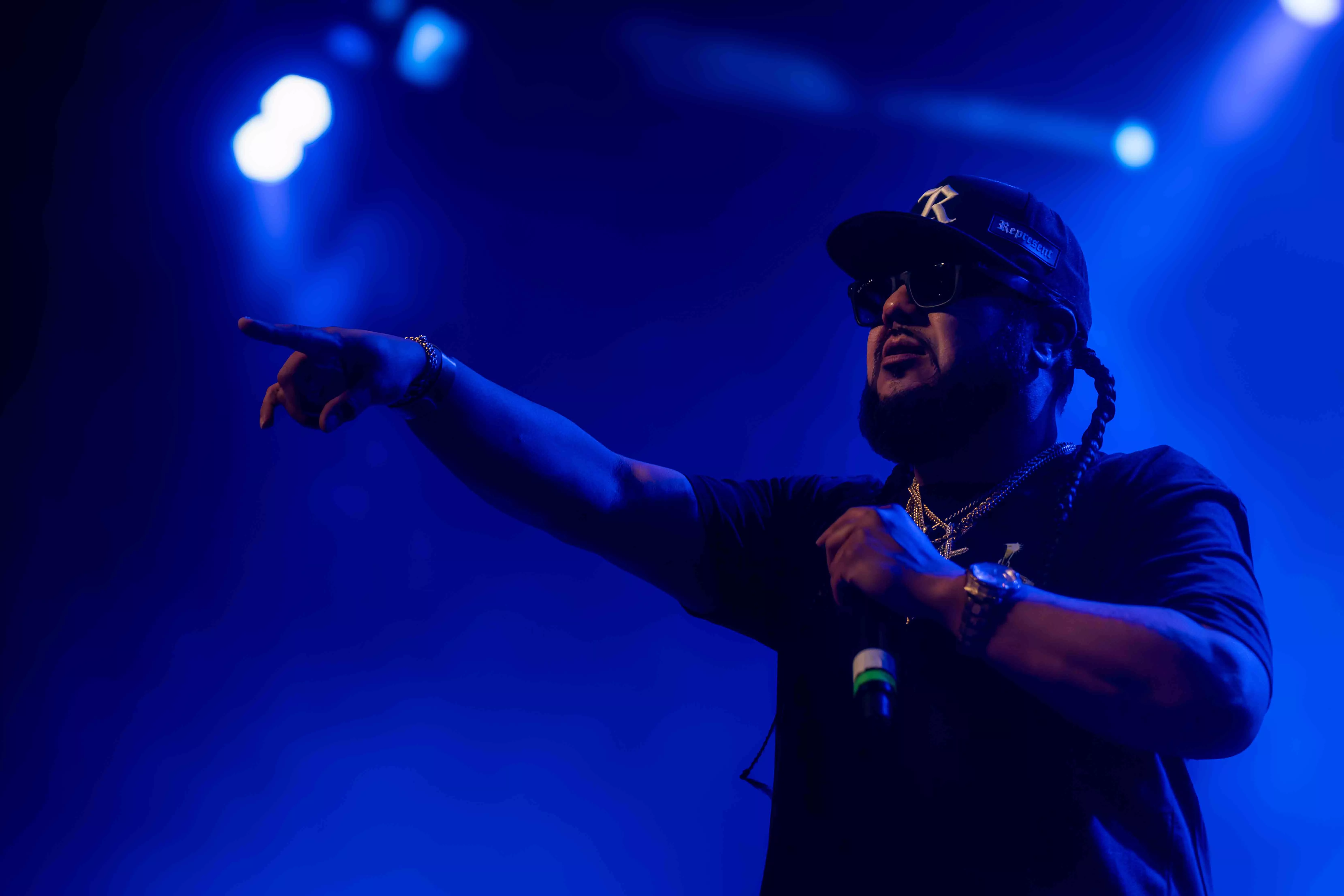 Stooie Bro points to the audience from the stage during the performance at the Riverside Municipal Auditorium