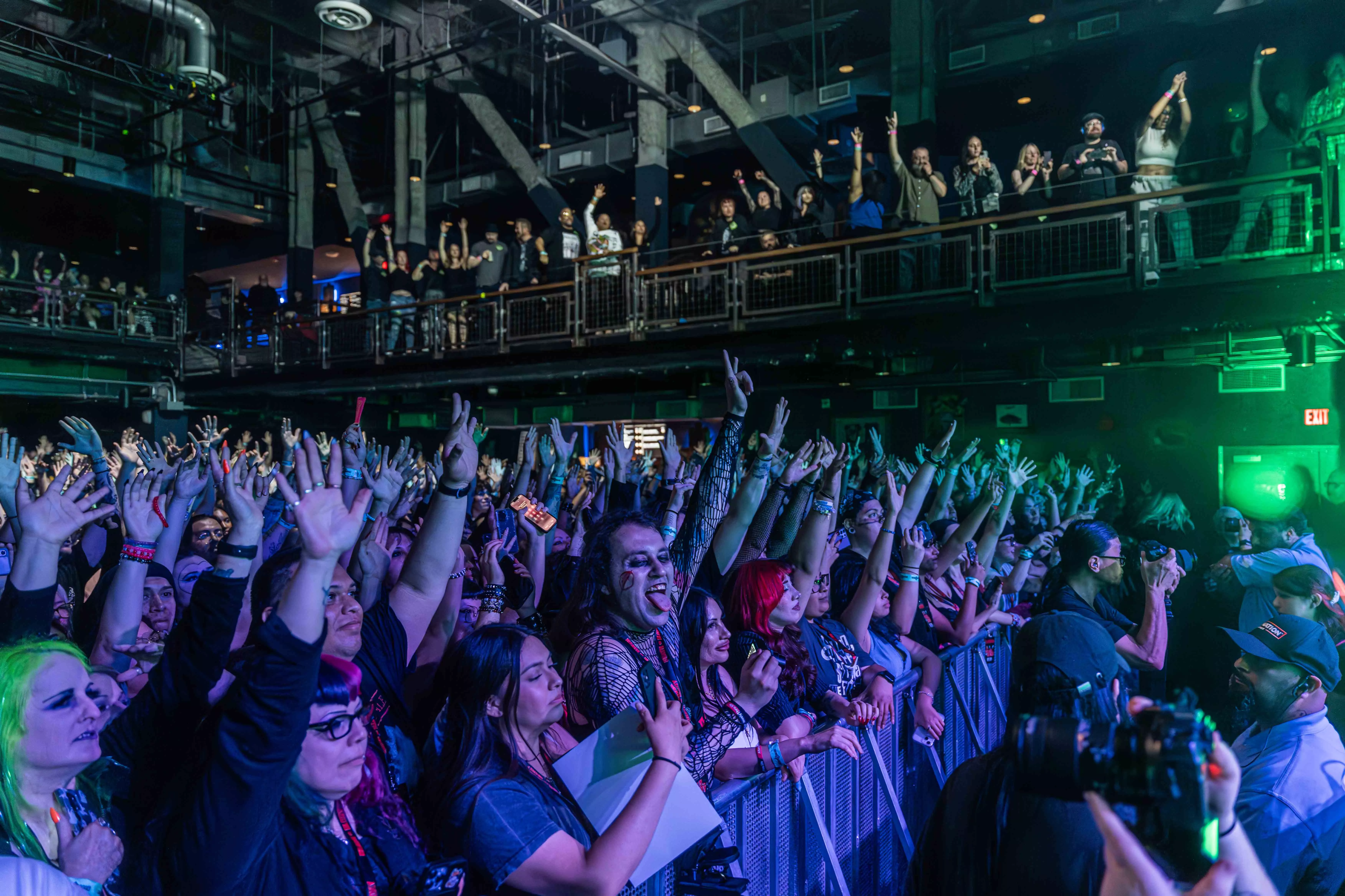 A crowd fills the venue House of Blues with their hands in the air