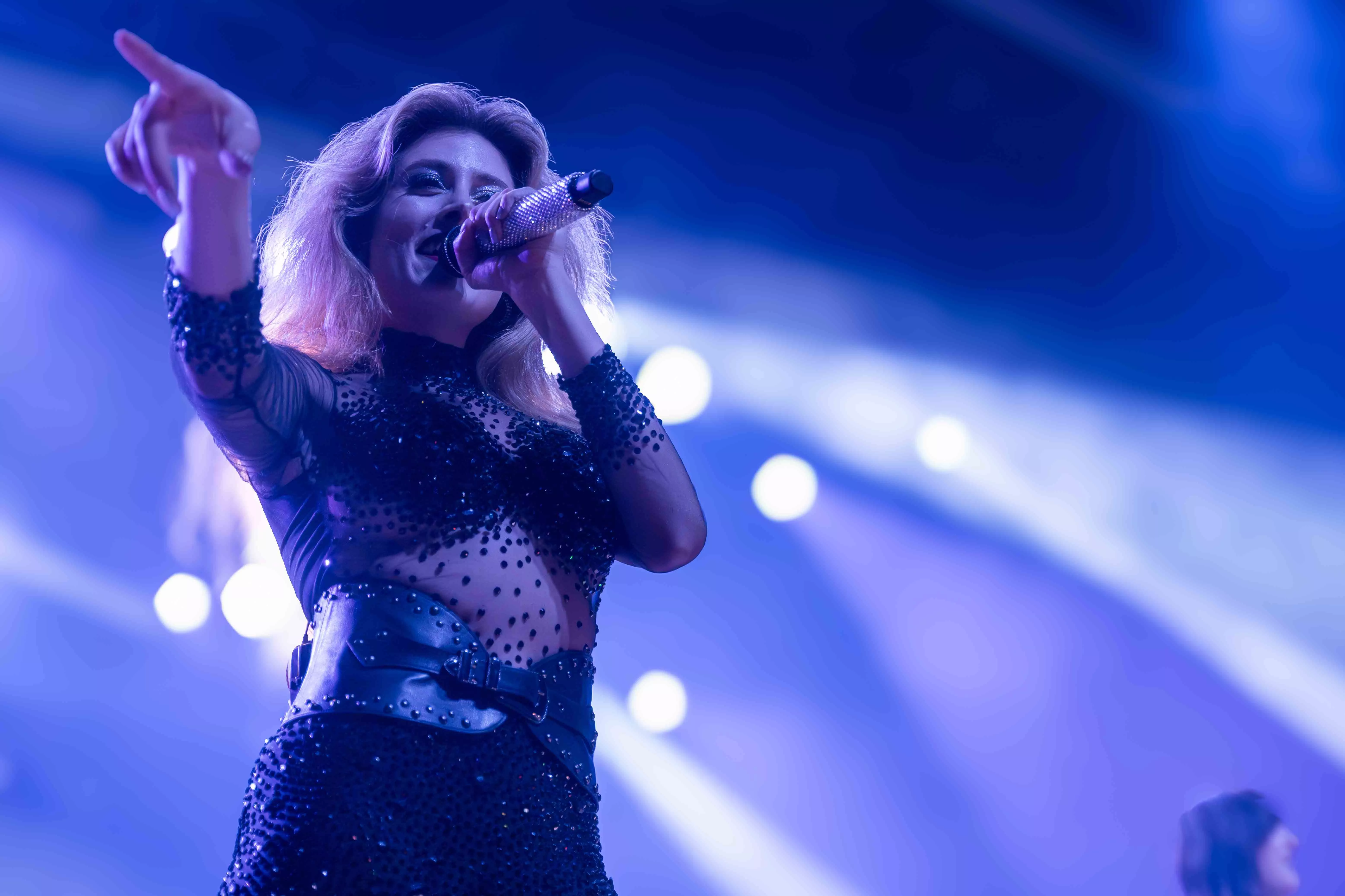 A female presenting performer sings on stage at the house of blues in anaheim ca