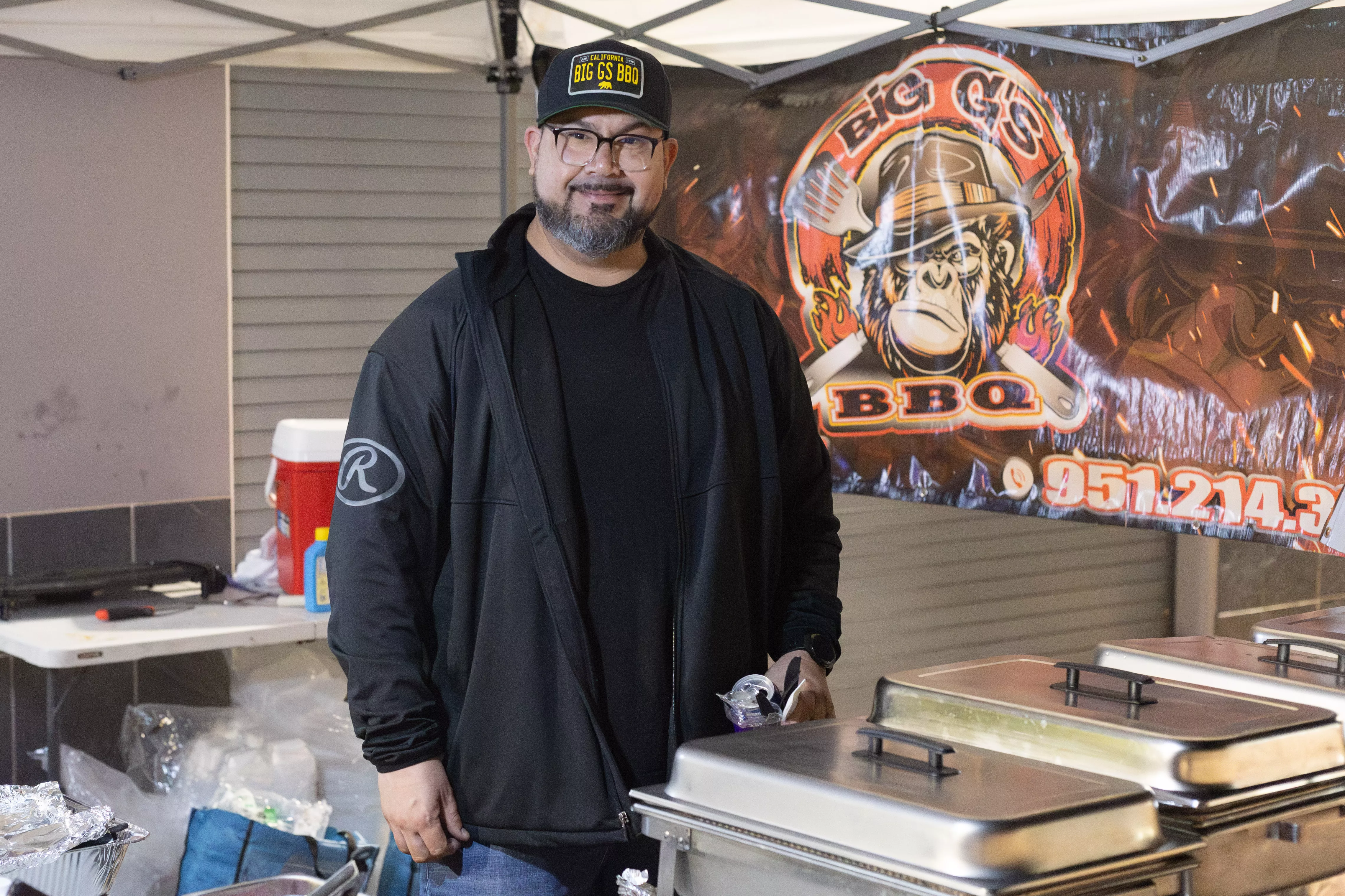 Carlos Granillo poses for a photo after finishing up with some BBQ