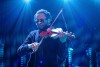 Claudias Agrippa plays the violin while on stage