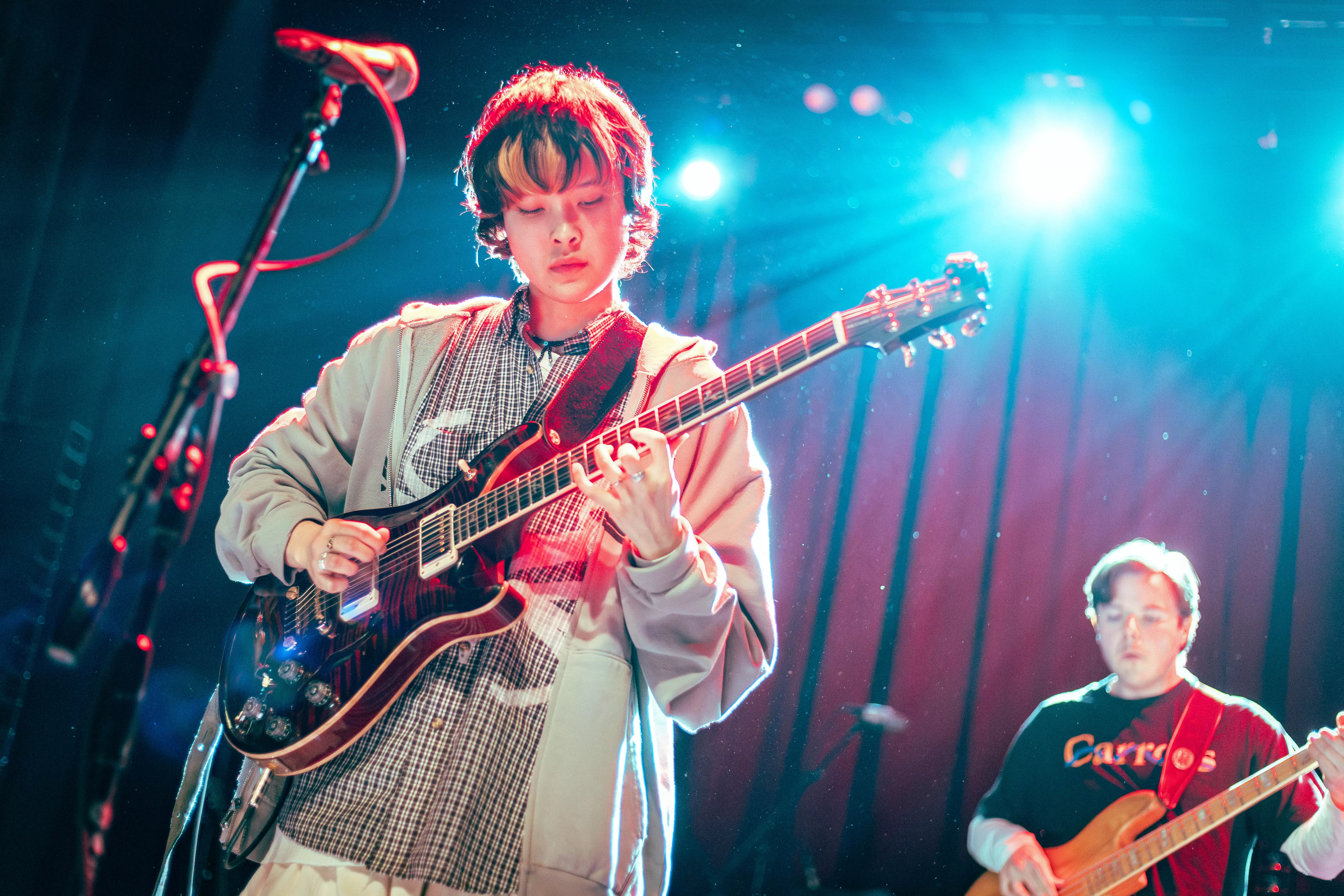 Mei Semones plays the guitar on stage