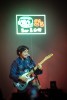 Grent performs under a neon sign