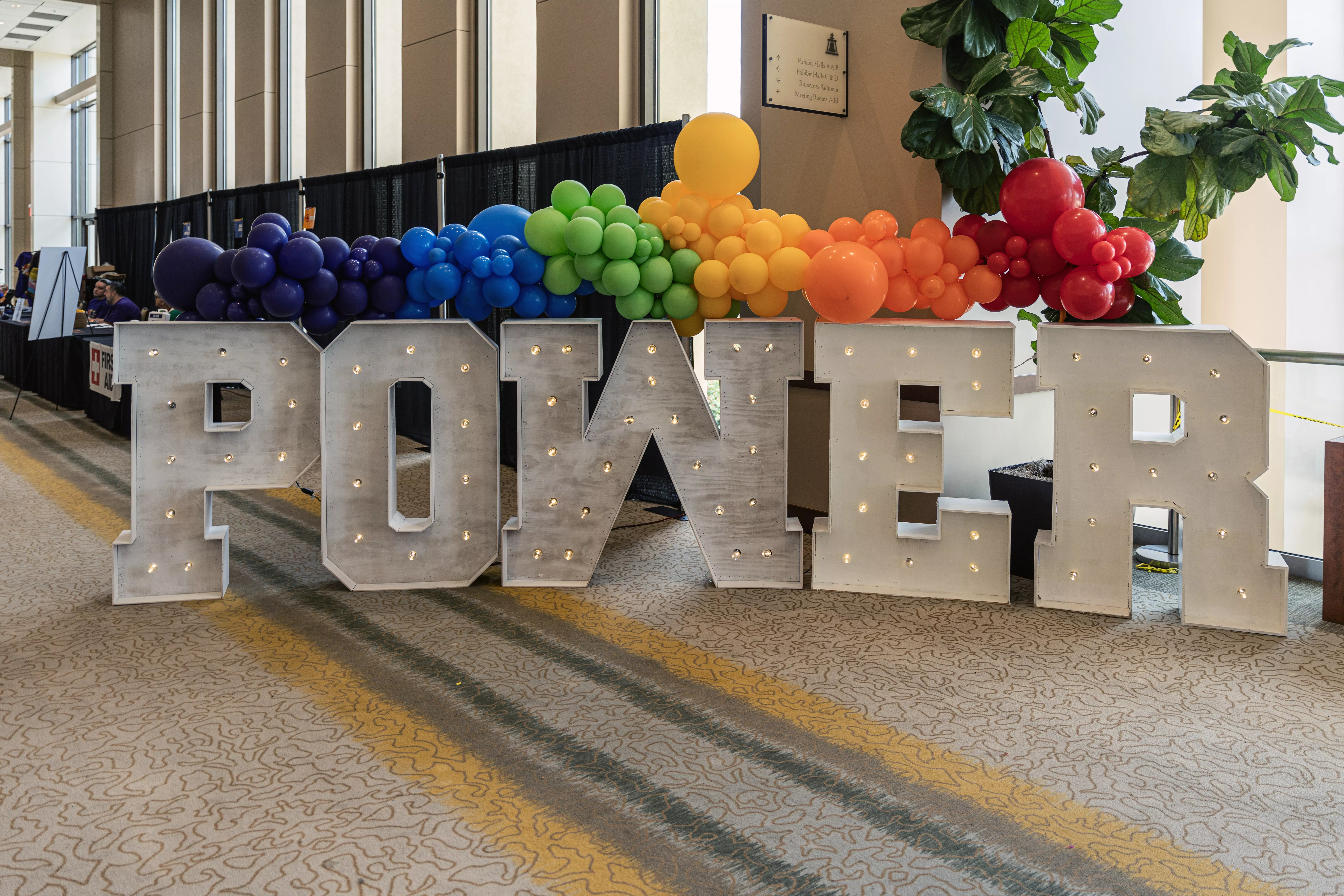 Power in Lights covered in rainbow colored baloons