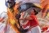 A woman dances with flags as part of a larger performance