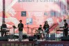 A group of young tweens perform in a band on stage