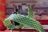 A young man dances with a dragon flag at the lunar festival