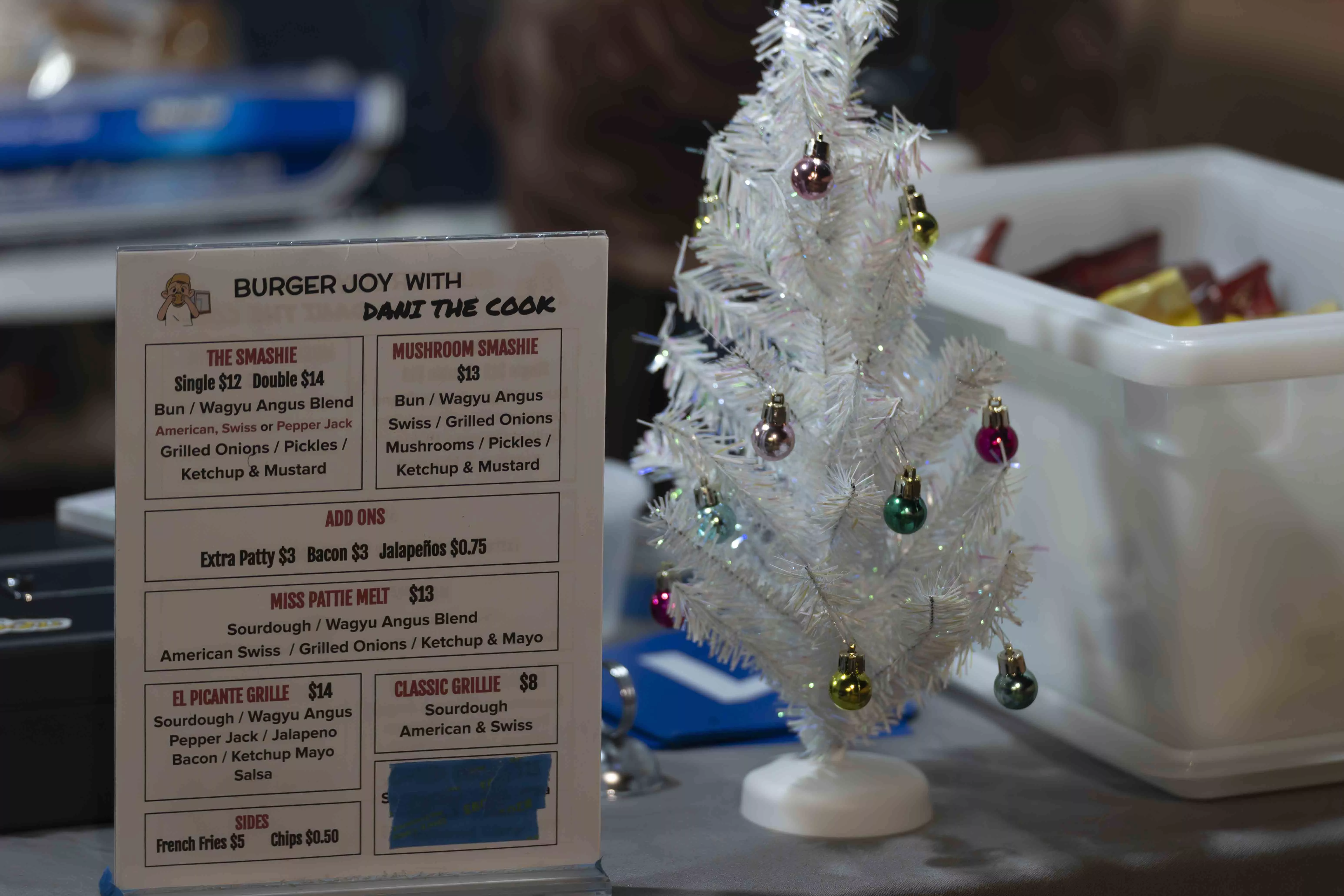 A text menu next to a small white decorated Christmas tree