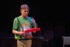 Performer holds snacks on stage