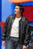 A young man playing Roger in the musical Grease