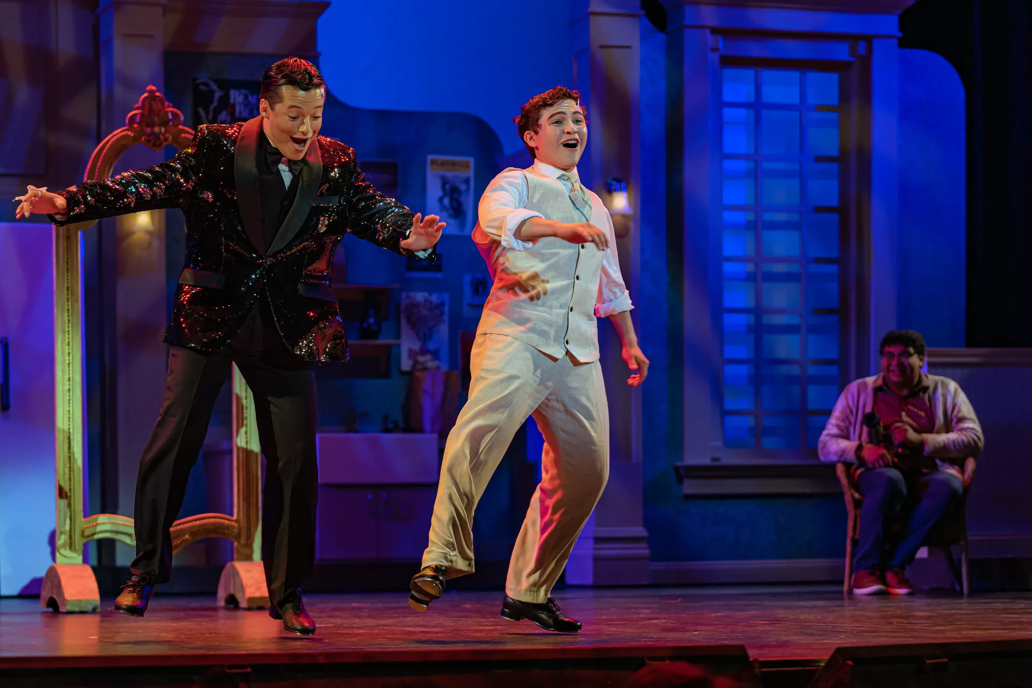 Actors tap dance on stage